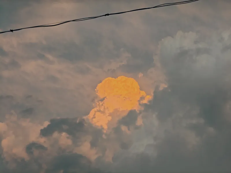 A burst of golden light amidst the stormy grey.