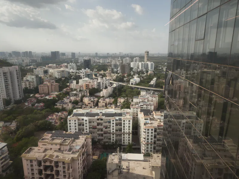 A sprawling urban tapestry mirrored in modern glass.