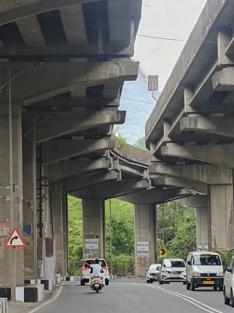 Concrete giants framing the path to a green horizon.